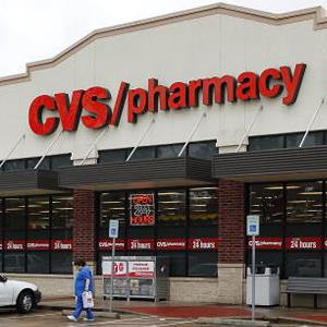 A woman carries a bag as she leaves a CVS store in Houston, Texas, U.S., on Tuesday, Dec. 8, 2009. A Texas pension fund will decide this week whether to award CVS Caremark Corp. a new pharmacy-benefits contract valued at almost $1 billion after the state's attorney general sued the company for alleged Medicaid fraud. Photographer: Aaron M. Sprecher/Bloomberg via Getty Images