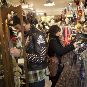 21-year-old Denise Romero looks for a blouse while shopping in a Brooklyn, N.Y. thrift store © Robert Nickelsberg/Getty Images