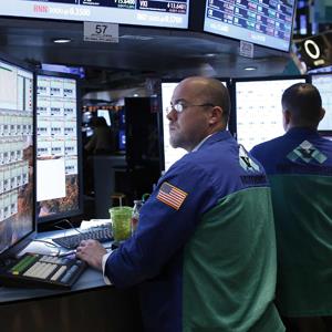 Trader Jarret Johnson of Virtu Finalcial works on the floor of the New York Stock Exchange
© Chip East/Reuters
