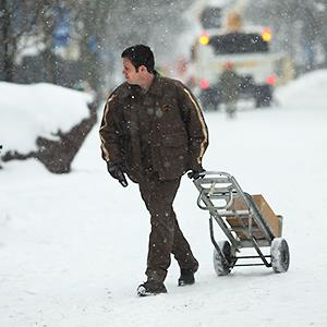 Caption: A UPS worker makes deliveries during a snow storm on February 5, 2014 in Burlington, Vermont
Credit: © Spencer Platt/Getty Images